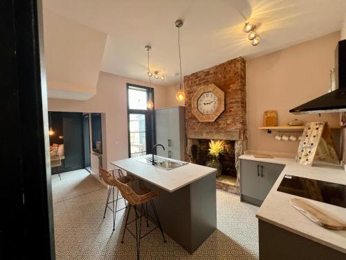 a kitchen with a sink and a fireplace at Lancaster Place 20 in Carnforth