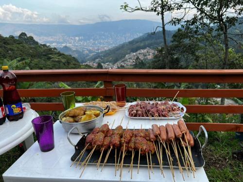a grill with meat and other food on a table at finca casita el mirador in Medellín