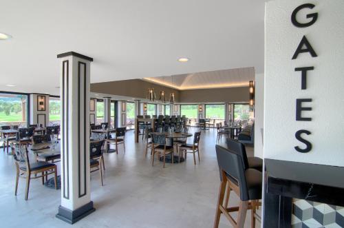 a dining room with tables and chairs and a sign at Cheyenne Mountain Resort, a Destination by Hyatt Hotels in Colorado Springs
