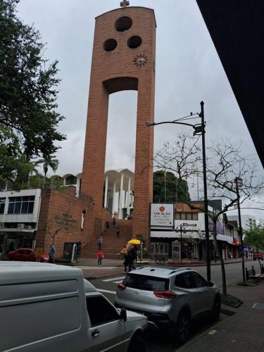a tall brick clock tower with a large window at AP Novo, Cama Queen Size Nova no Centro de Blu in Blumenau