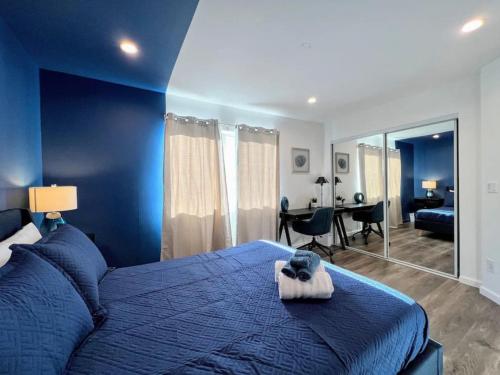 a blue bedroom with a bed and a desk at Trendy 2BR Near Hollywood Hotspots - BR9 in Los Angeles