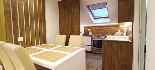 a small kitchen with a table and a sink at Boutique Apartment in Sarajevo