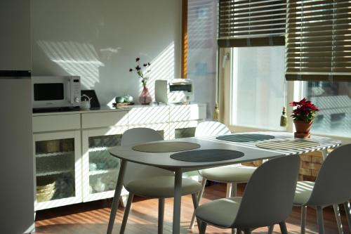 a dining room with a table and chairs in a kitchen at Stay Vibe Healing House in Seoul