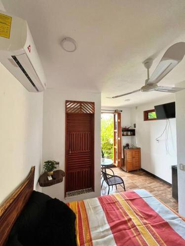 a bedroom with a bed and a door to a kitchen at Casa Guiba 3 Puerto Escondido in Puerto Escondido