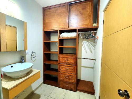 a bathroom with a sink and a cabinet and a mirror at Bahia del tezal 202b: 2BR/2BT Condo, Big pool, 5 minutes walk to Beach! in Cabo San Lucas