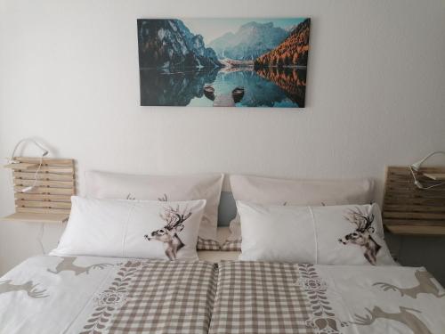 a bedroom with a bed with two deer heads on it at Apartma Traumblick Obertraun in Obertraun