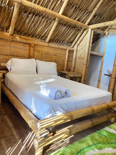 a bedroom with a bed in a straw hut at Guajira Beach in Ríohacha