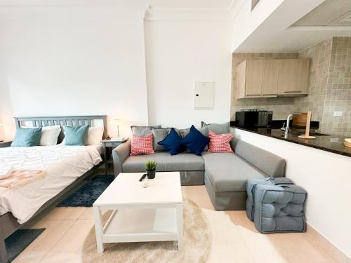 a living room with a couch and a table at Spacious Studio in Yas Island 113A1 in Abu Dhabi