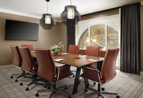 a conference room with a wooden table and chairs at The Union Station Nashville Yards, Autograph Collection in Nashville