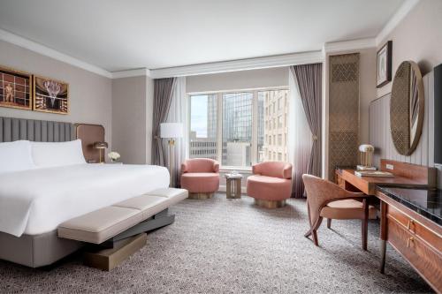 a hotel room with a bed and a desk at The Ritz-Carlton, Dallas in Dallas