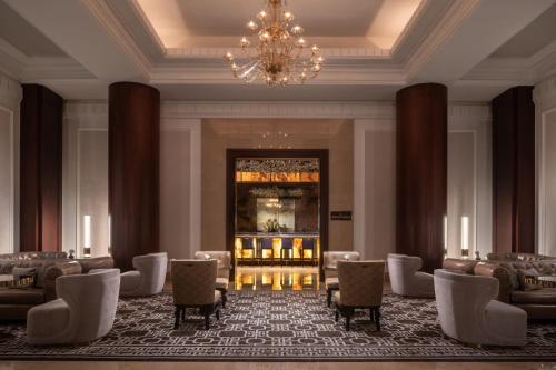 a lobby with chairs and a chandelier in a building at The Ritz-Carlton, Dallas in Dallas
