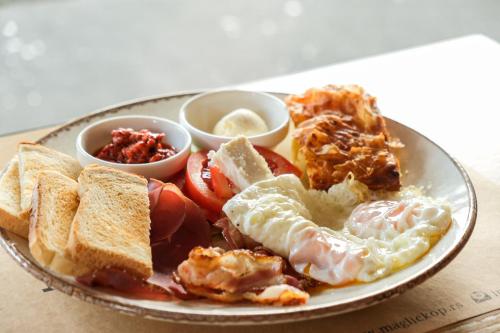 a plate of breakfast food with eggs and toast at Apartments Pavle in Kopaonik