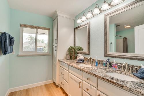 a bathroom with two sinks and a mirror at Waterfront North Fort Myers Home with Private Pool! in North Fort Myers