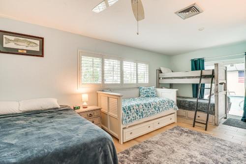 a bedroom with a bed and a bunk bed at Waterfront North Fort Myers Home with Private Pool! in North Fort Myers