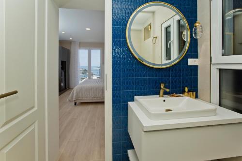 a bathroom with a sink and a mirror at Villa Milton Luxe Rooms in Hvar