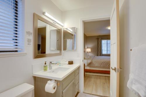 a bathroom with a sink and a mirror and a bed at Modern Tahoe City Home Close to Beaches! in Tahoe City
