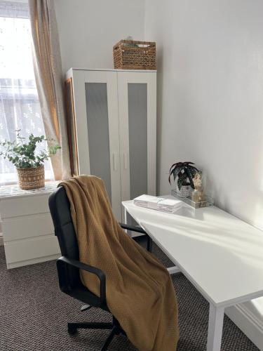 an office with a desk and a chair with a blanket at Monk's Lodge Private En-suite Room CV1 in Parkside