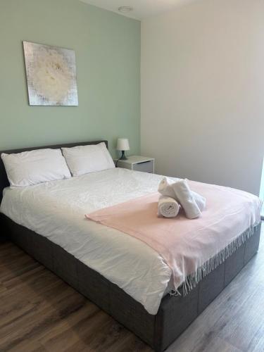a bedroom with a bed with two towels on it at Modern 2BR Sleeps 4 Easy Access to City Centre in Manchester