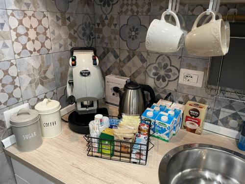 a kitchen counter with a coffee maker on a counter top at Miambra in Grumo Nevano