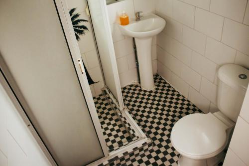 a bathroom with a toilet and a sink at Hostal Salvador in Santiago