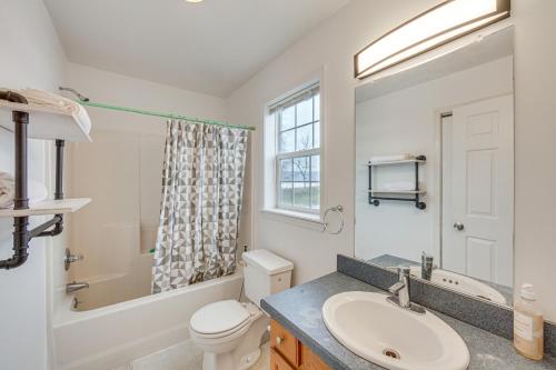 a bathroom with a sink and a toilet and a window at Pet-Friendly Grantville Home about 8 Mi to Hersheypark in Grantville