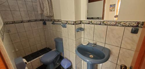 bagno con lavandino blu e servizi igienici di Hospedaje Olguita a Oxapampa