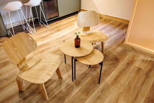 two tables and two chairs with a bottle on it at The Somos Central Hotel Poblado in Medellín