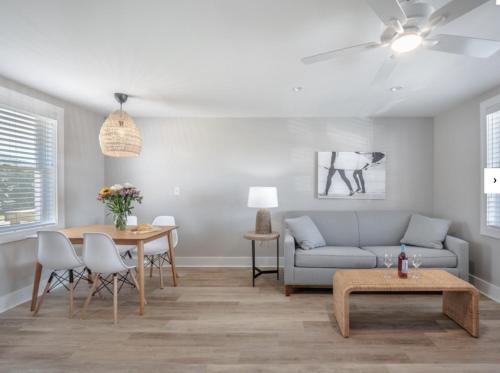 a living room with a couch and a table at The Beach House at Oak Island by North State Hospitality in Oak Island