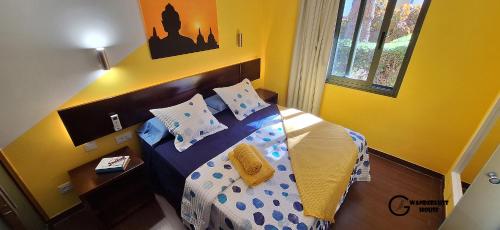 a bedroom with a bed with blue and yellow at Atlantic Garden Wanderlust House in Corralejo
