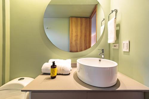 a bathroom with a white sink and a mirror at The Somos Central Hotel Poblado in Medellín