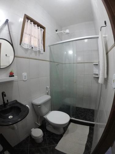 a bathroom with a shower and a toilet and a sink at Casa Flora in Cabo Frio