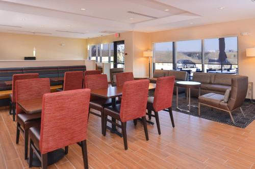 a dining room with tables and chairs and a couch at TownePlace Suites by Marriott Gillette in Gillette