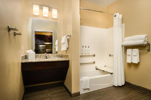 a bathroom with a tub and a sink and a shower at TownePlace Suites by Marriott Houston Galleria Area in Houston