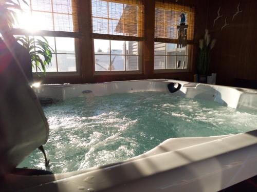 a bath tub filled with water in a bathroom at Hot Tub Hideaway 3 BR in Jeffersonville