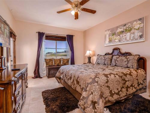 a bedroom with a bed and a ceiling fan at Luxury San Felipe Mexico Golf Course Condo in San Felipe