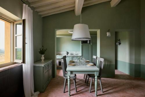 a dining room with a table and chairs at Castello Del Nero - Podere San Filippo in Tavarnelle in Val di Pesa