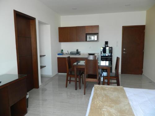 a kitchen and dining room with a table and chairs at ACL Suites in Boca del Río