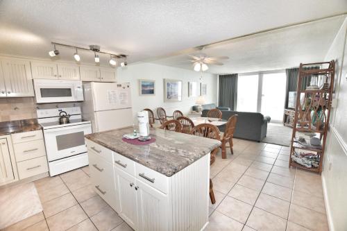 a kitchen and living room with a table and a couch at 0512 Waters Edge Resort condo in Myrtle Beach