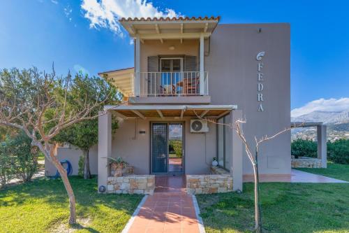 a house with a front door with a balcony at Fedra Plakias Apartments in Plakias