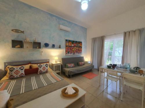 a living room with a bed and a table in it at Apartamento Cadaques caribe Bayahibe in Bayahibe