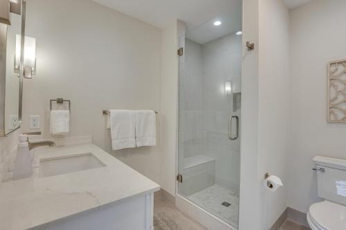 a white bathroom with a shower and a sink at Silverthorne Townhome with Hot Tub Walk to Town! in Silverthorne