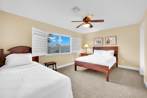 a bedroom with two beds and a ceiling fan at Oasis Retreat at Henderson Greens in Las Vegas