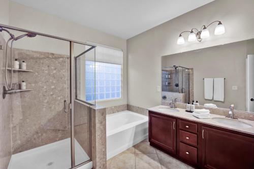 a bathroom with a shower and a tub and a sink at Todor Las Vegas Home Away From Home in Las Vegas