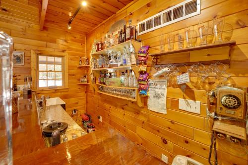 a kitchen in a wooden cabin with a counter at Riverfront Luther Cottage with Year-Round Trail! in Luther