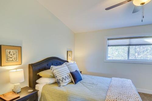a bedroom with a bed with pillows and a window at Cedar City Home with Mountain Views and Game Room! in Cedar City