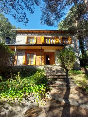 a house with stairs leading up to it at Villa Zocotin in Villanúa