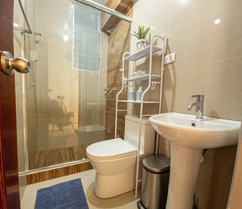 a bathroom with a toilet and a sink and a shower at Varvel residence in Cusco