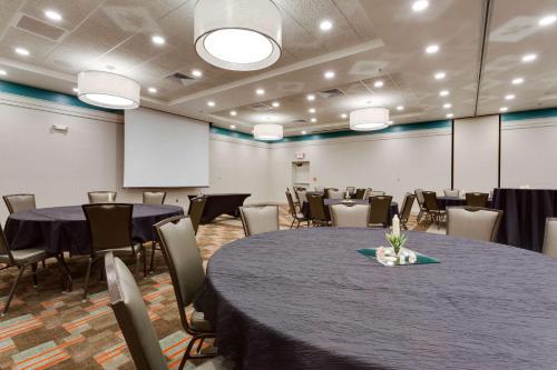 a conference room with tables and chairs in it at Drury Inn & Suites Fort Myers Airport FGCU in Fort Myers