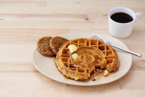a plate of waffles and cookies with a cup of coffee at Drury Inn & Suites Fort Myers Airport FGCU in Fort Myers