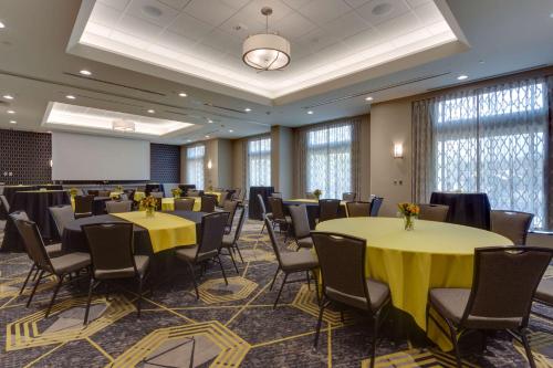 a conference room with tables and chairs and windows at Drury Inn & Suites Pittsburgh Airport Settlers Ridge in Pittsburgh